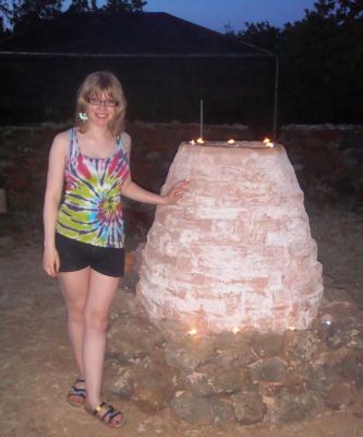 Figure 2. Author standing next to pottery kiln (Photo credit: Author)
