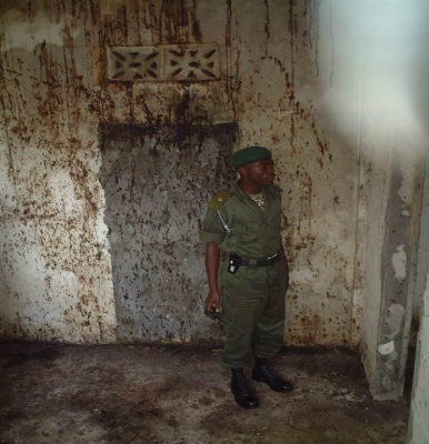 Figure 4: Officer of the recently formed Republic of Sierra Leone Armed Forces examining the Killing House in Kailahun (Reproduced with kind permission of M. Russell)