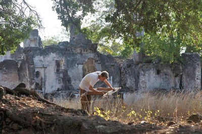 Figure 1. ‘Stone Towns of Swahilli Coast’, Samir S. Patel’s article for Archaeology. Excavations at the medieval Swahili town of Songo Mnara in Tanzania are yielding a wealth of detail about Swahili home life and its connection to global trade routes. Here, a student sifts material from a dig in one of the stone homes (image copyright: Samir S. Patel).