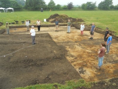 Figure 1. Team members showing the position of revealed post-holes prior to excavation in 2013 (image copyright by author).